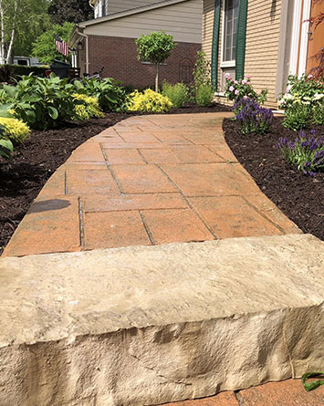 paved walkway installation, stone slab and mulch garden